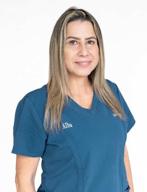 Professional headshot of female orthodontic staff member in blue scrubs against white background.